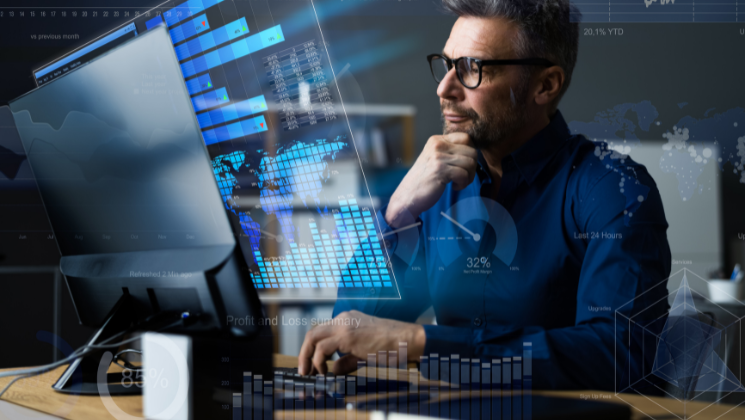 Photo of a man by a computer